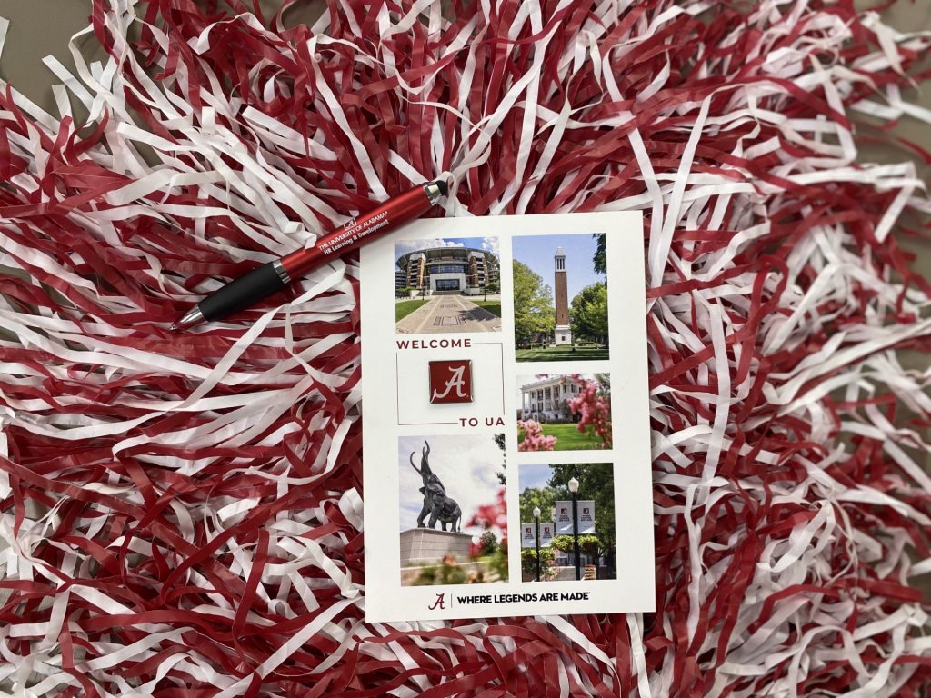 red and white shakers with an alabama pin attached to a card